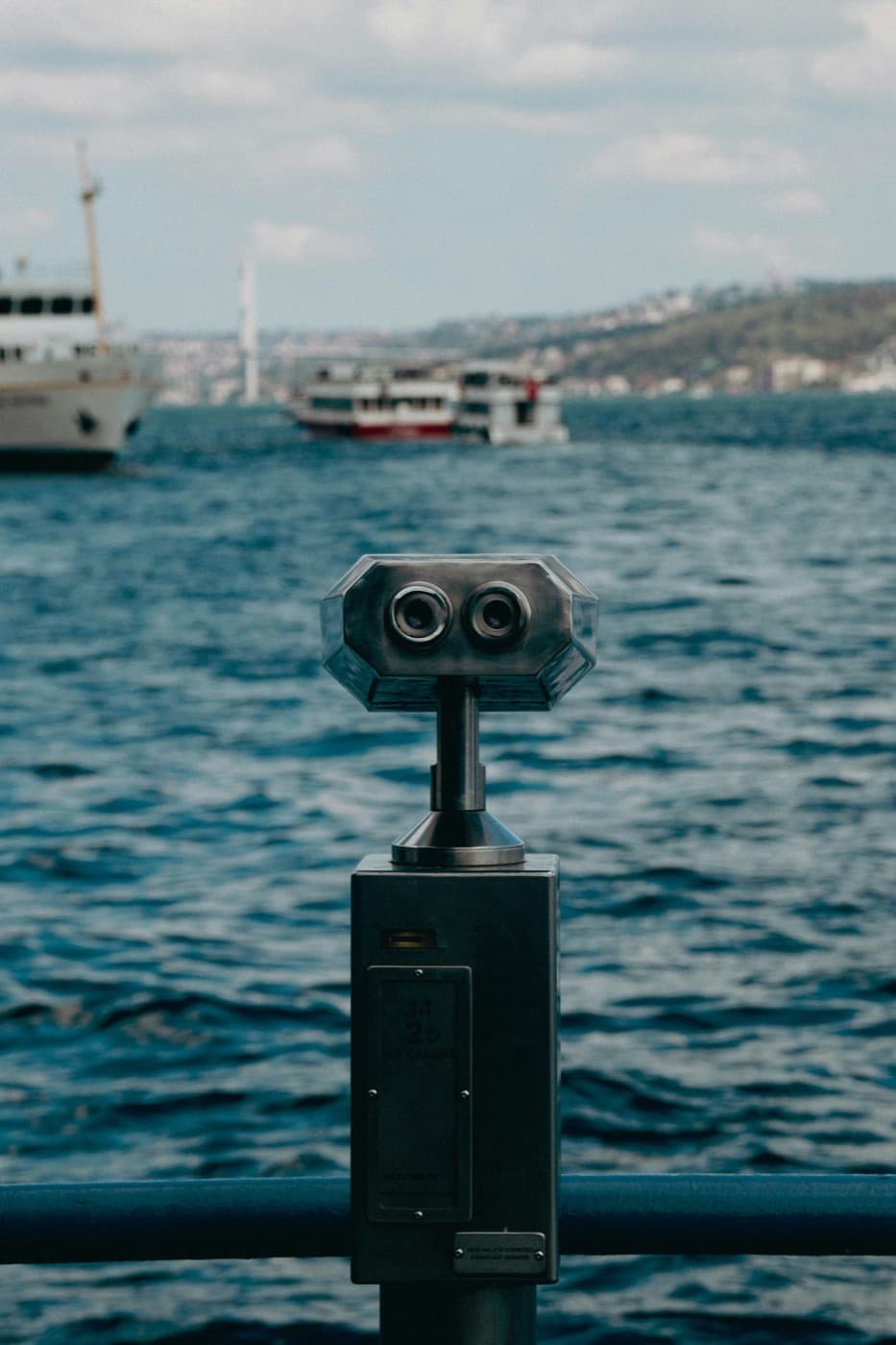 A coin-operated viewfinder overlooking a harbour