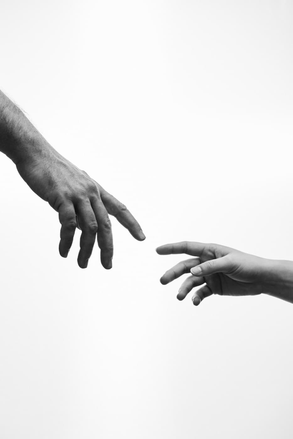 Two hands reaching toward each other